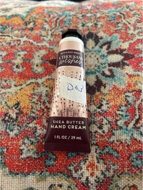 D63 1 Bath and Body Works hand cream 1 oz a thousand wishes